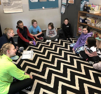 students sitting on the floor